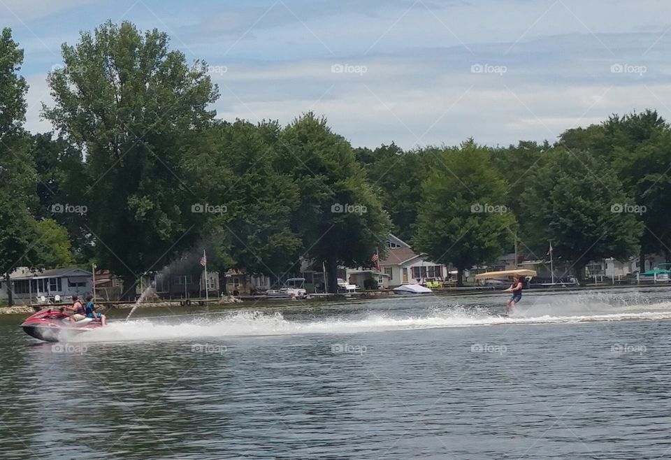 Water Skiing behind a jet ski.