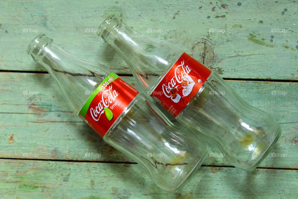 bottles of Coca cola on a wooden table