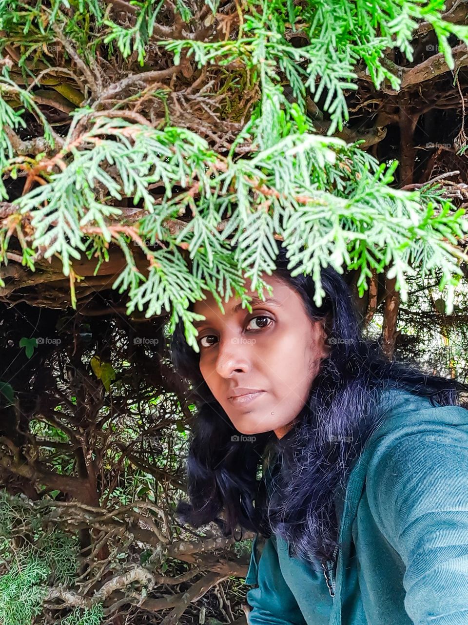 woman under the branch of the tree