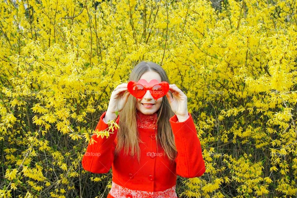 Woman holding red sunglasses