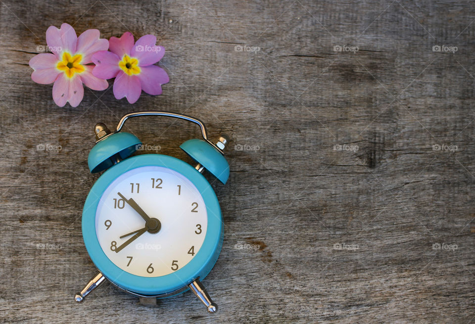 Blue clock and pink flowers