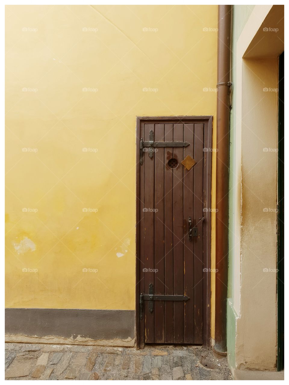 In a small empty street I found this little door. Beautiful yellow wall!
