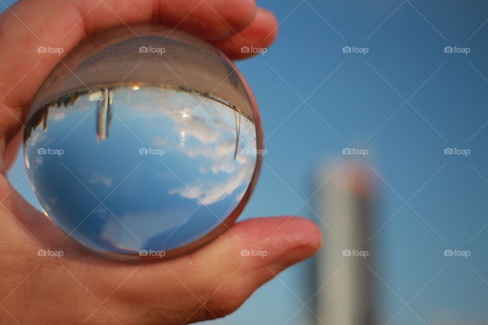 crystal glass ball in hand with cityscape view