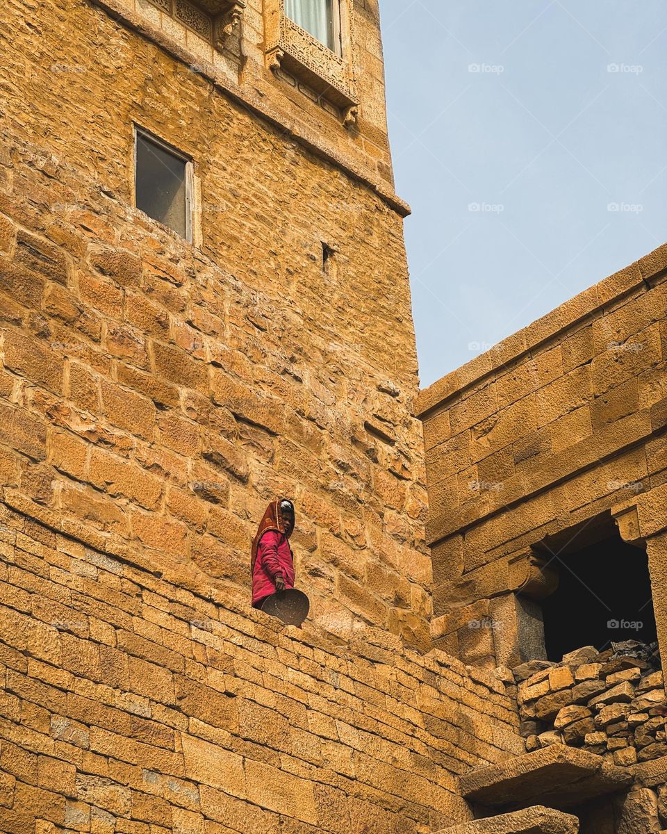 A photo of woman working in the jaisalmer fort