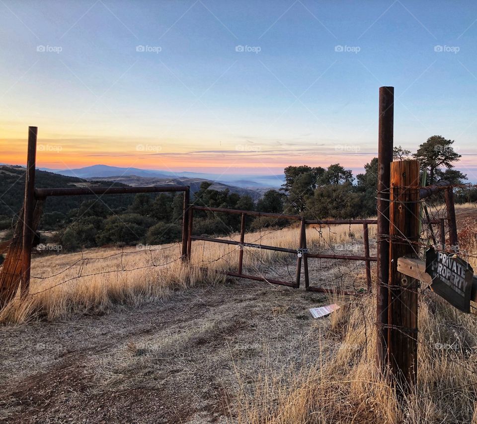 A beautiful sunset behind a country fence