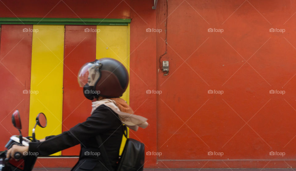 savety rider with red wall background