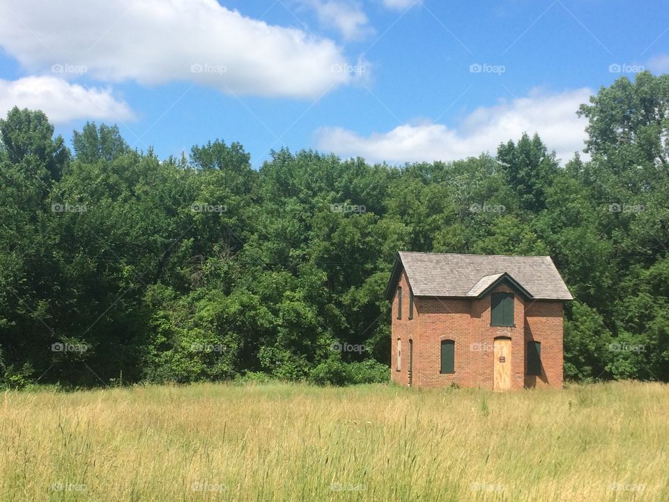 Old abandoned house in field 
