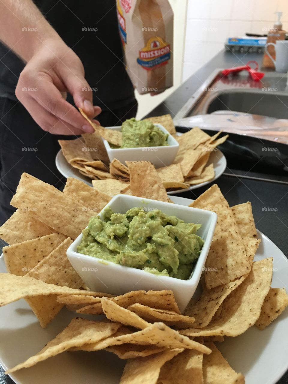 Spinach hummus dip and corn chips closeup 