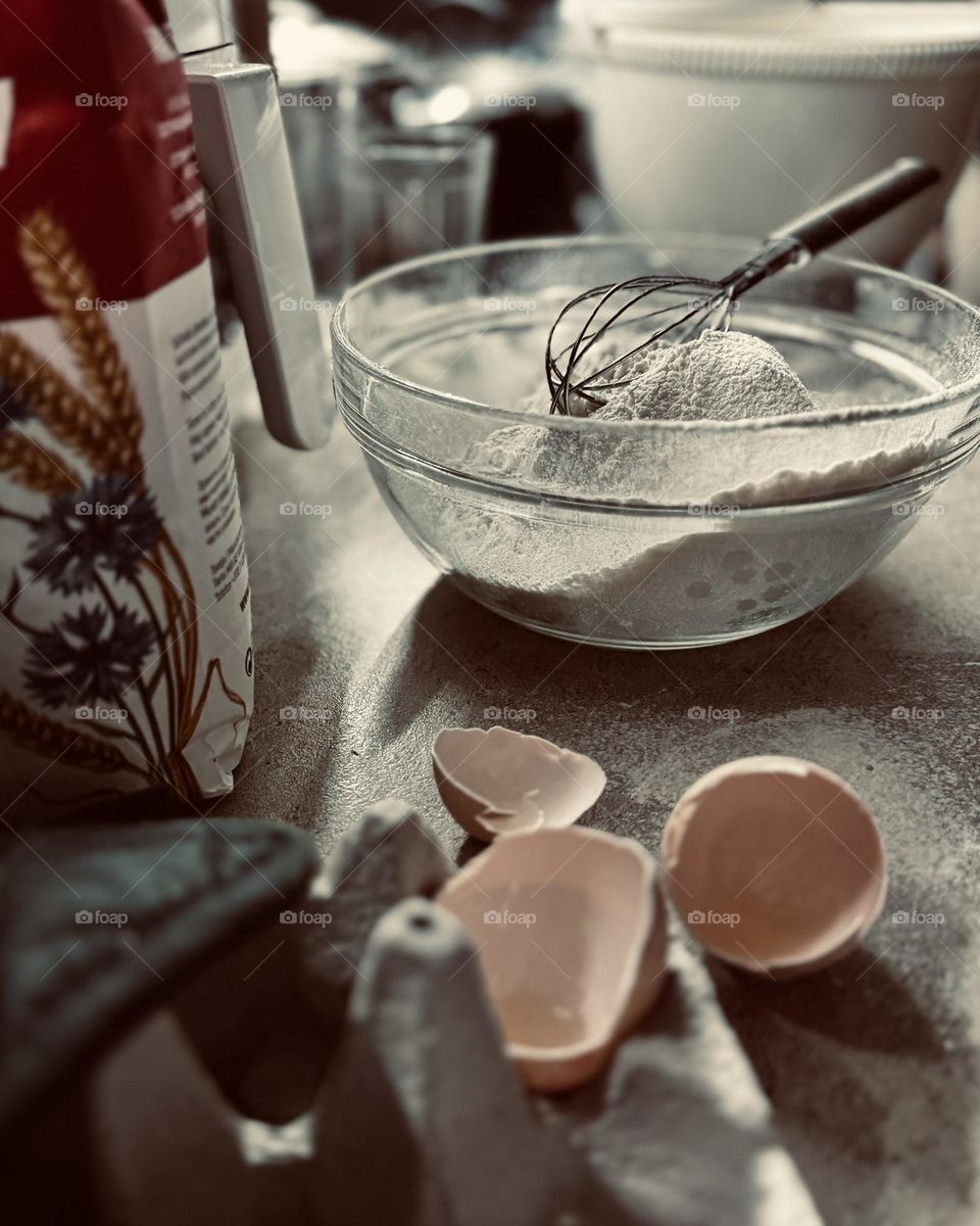 Cooking time, a bowl of flour and egg shells standing on the table