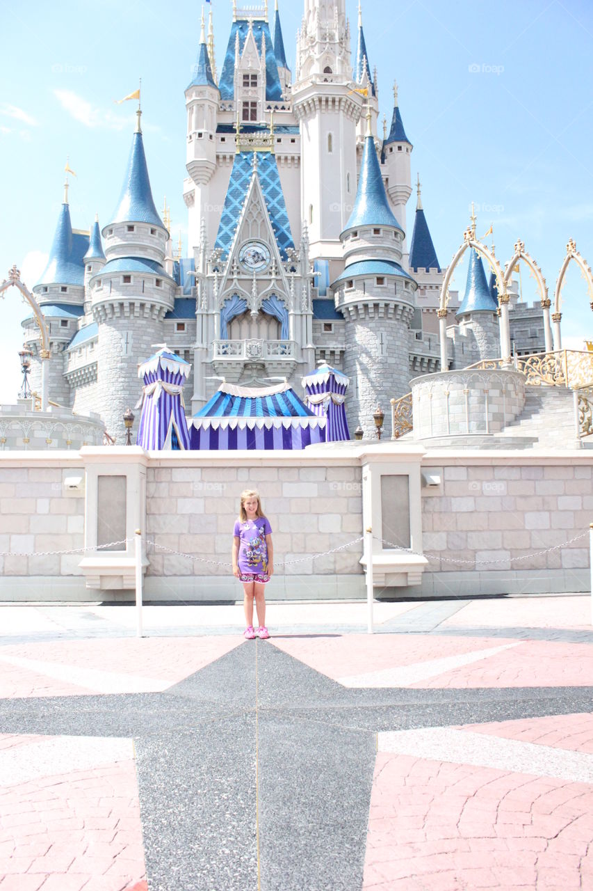 Truly magical. Girl standing in front of cinderella's castle at Walt Disney world