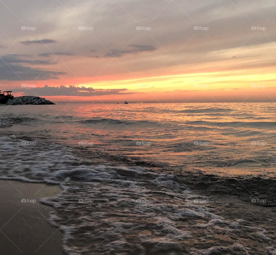 Beautiful sunset while watching the waves caress the shore. 