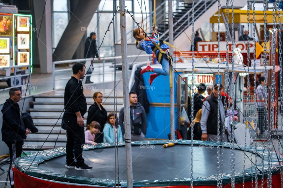 A girl jumps on a trampoline