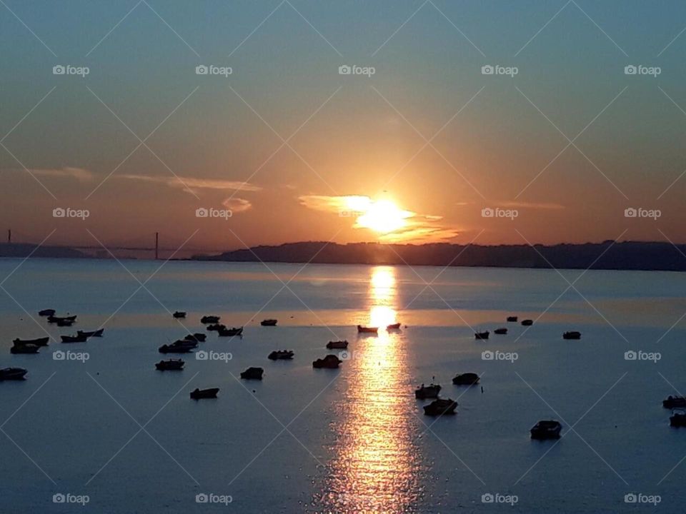 Sunset overlooking the 25 de Abril Bridge, from the Vasco da Gama Bridge, Tejo River, Lisbon
