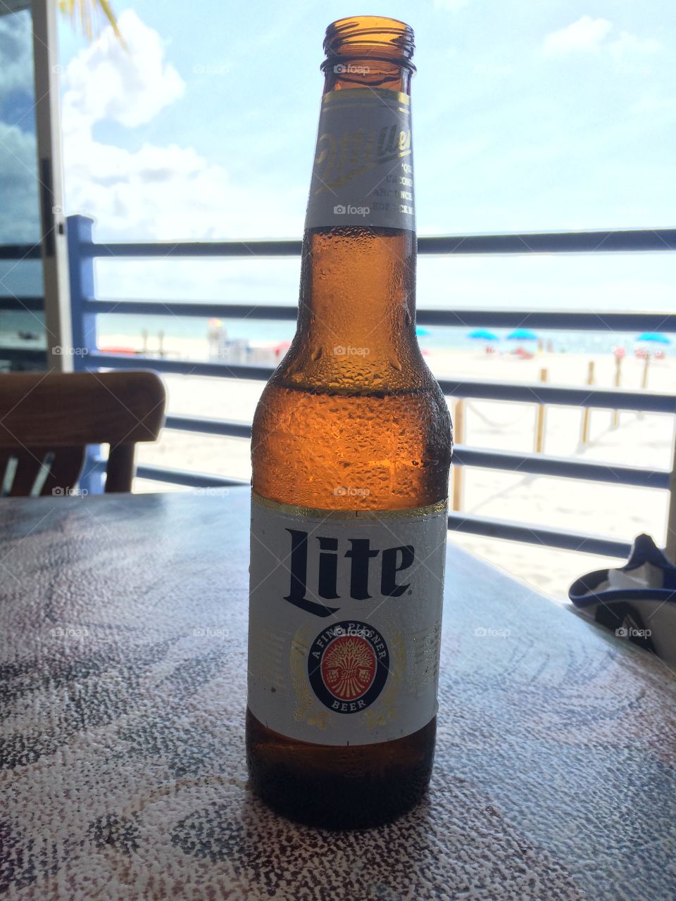 Beer on the Beach. Boyfriend drinks millerite. 
