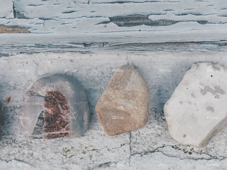 Three stones on a wooden background