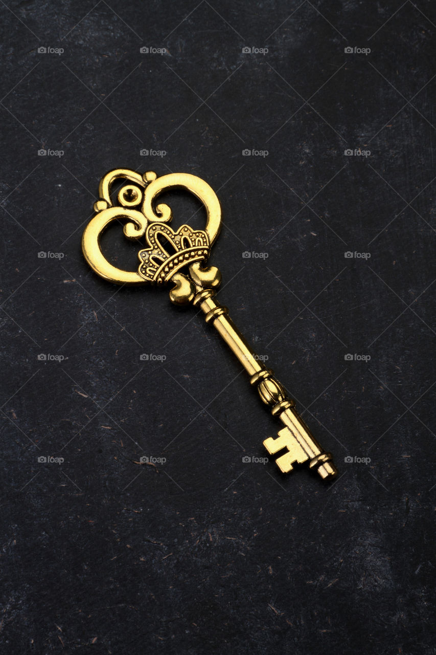 Beautiful antique vintage key on black background
