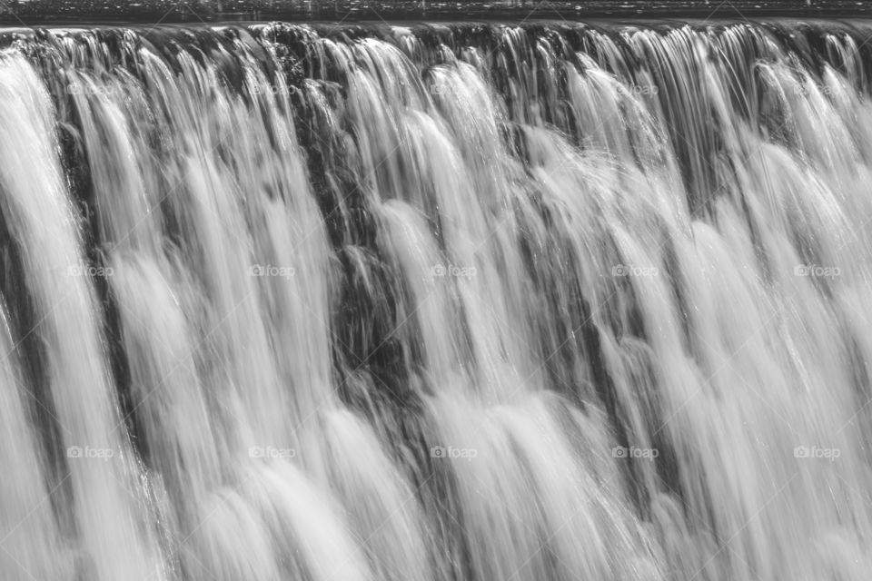 Wall of falling water in black and white