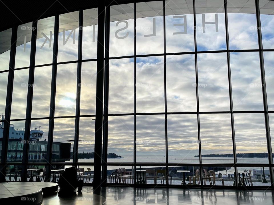 View through the wall size window to the cloudy sky and calm Baltic Sea from the hall of the new cruise ship terminal in Helsinki 