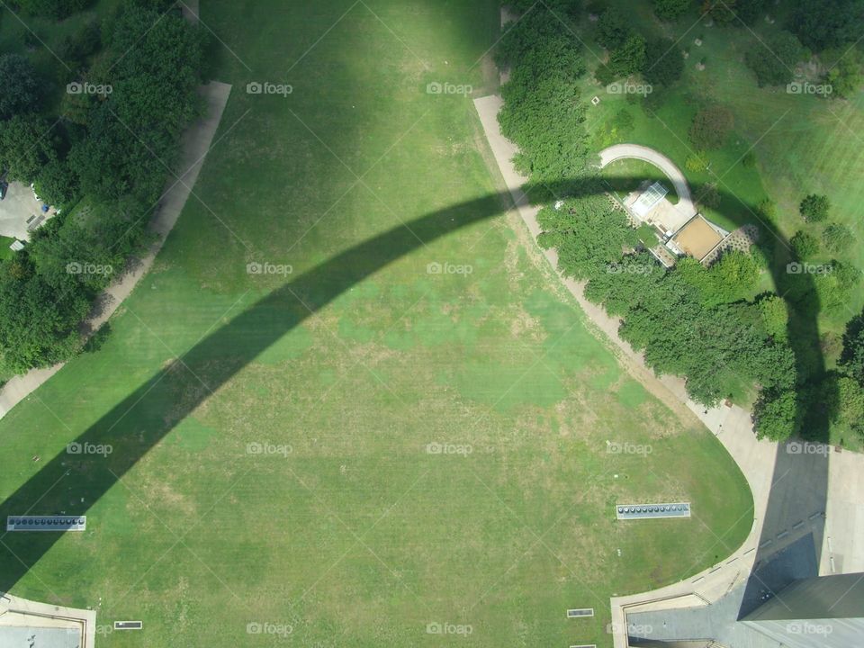 On top of St. Louis arch looking down to grass and shadow below