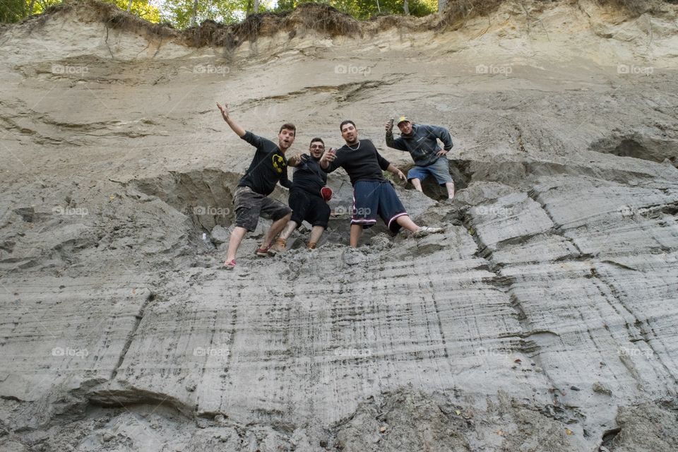 Low angle view of friends standing rock