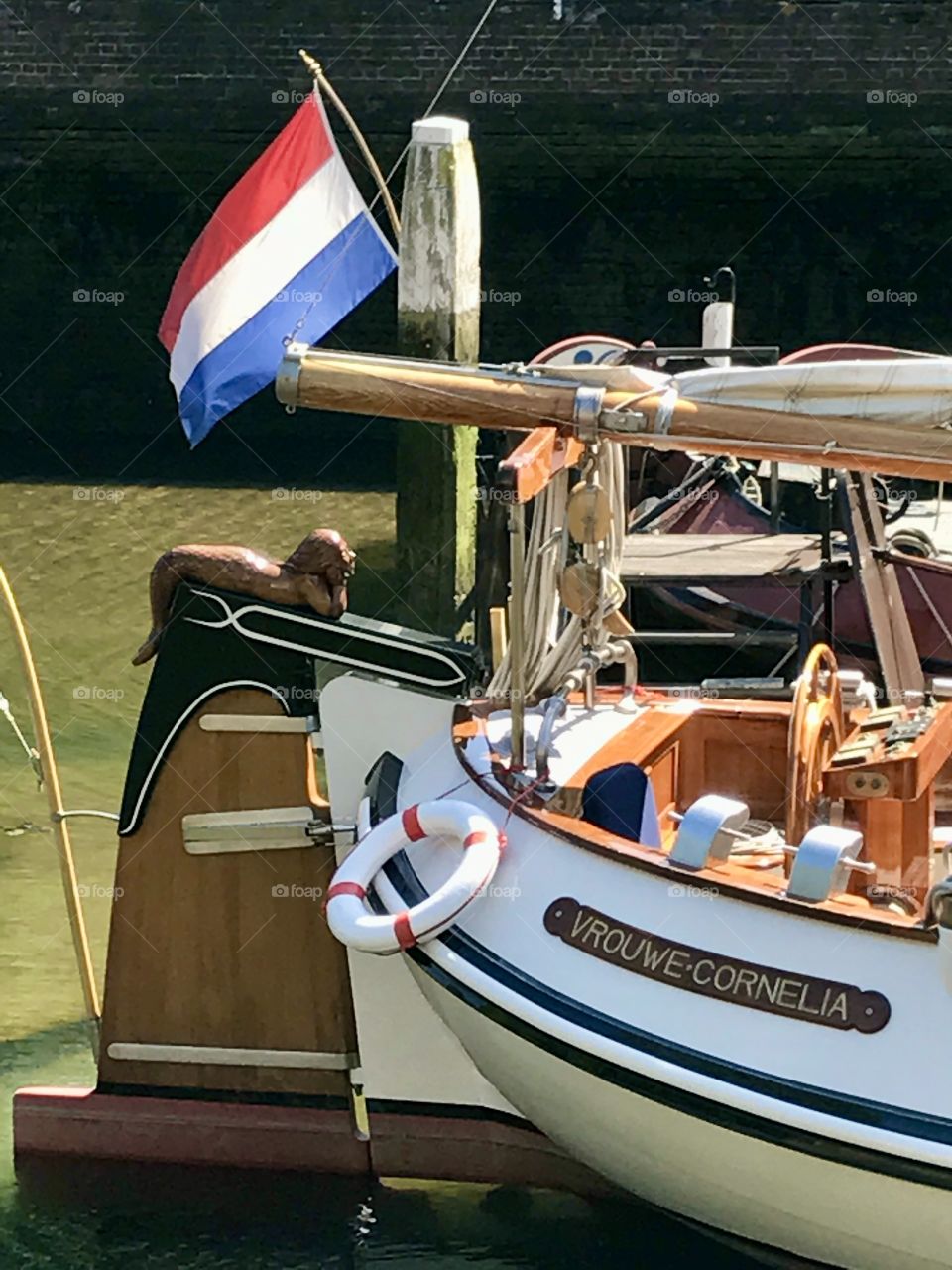 A boat with dutch flag on a channel 