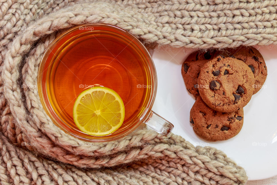 High angle view of lemon tea with cookie