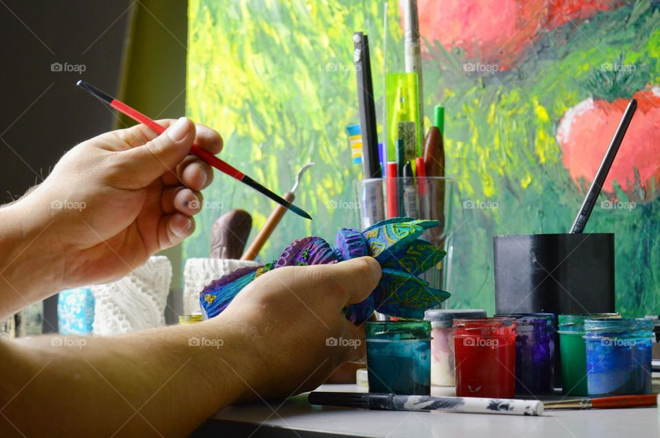 my home workshop for pouring and painting ceramic and earthenware jugs. The photo shows a jug being painted with acrylic.