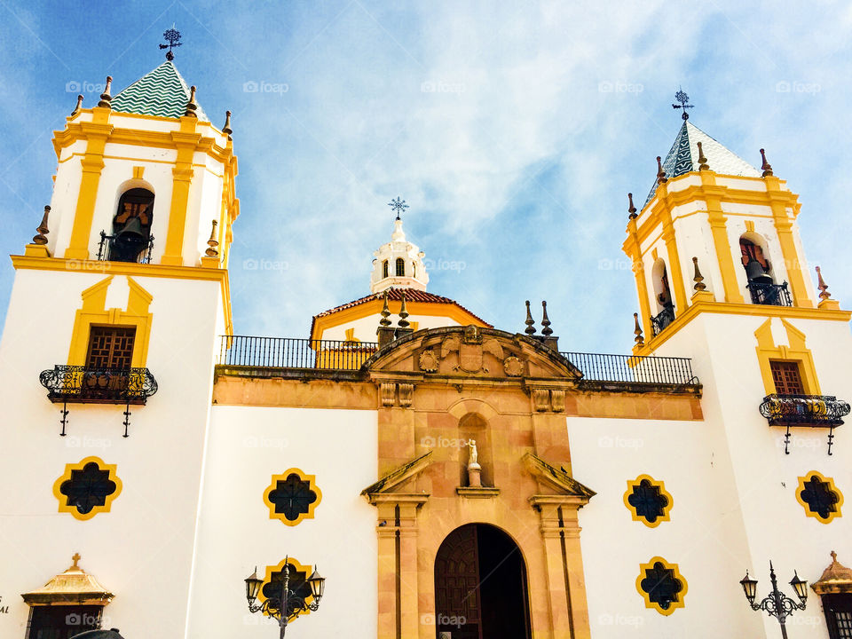 Vibrant Spanish church in Andalucia  with yellow feature and whit washed walls