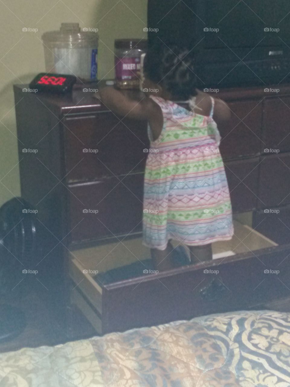 my baby girl climbing in drawer get some candy and peanuts off the