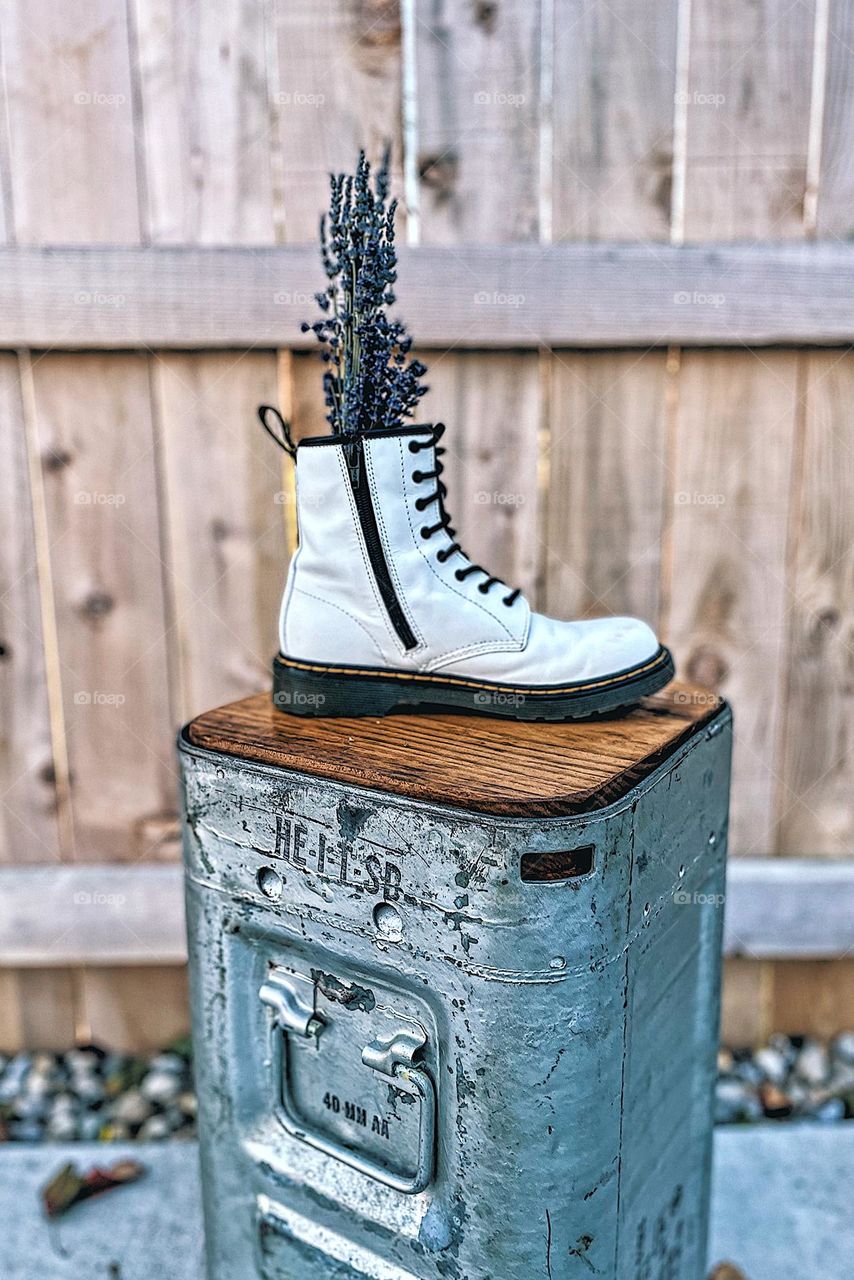 Doc Marten white boots with lavender stalks, Dr. marten boot as a vase, flowers and Docs, old school Dr. marten boots, DMs used creatively, boots as a vase, flowers and punk style, prom with Docs, ammo cans and Dr. Marten boot 