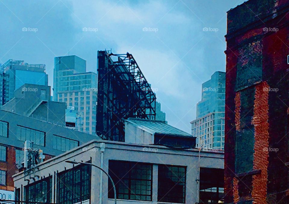 Buildings and a construction site with scaffolding and machinery in the overcast setting of a cool autumn afternoon in Long Island City, Queens, NY. 2019. Hypnotic Productions