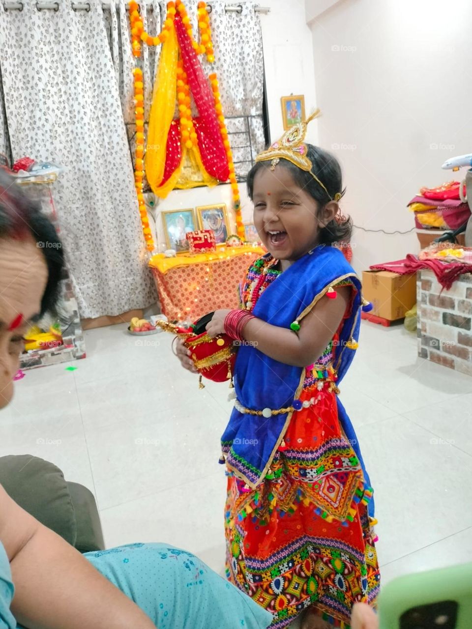 pure smile which touched the heart, a baby girl decorated as lord krishna