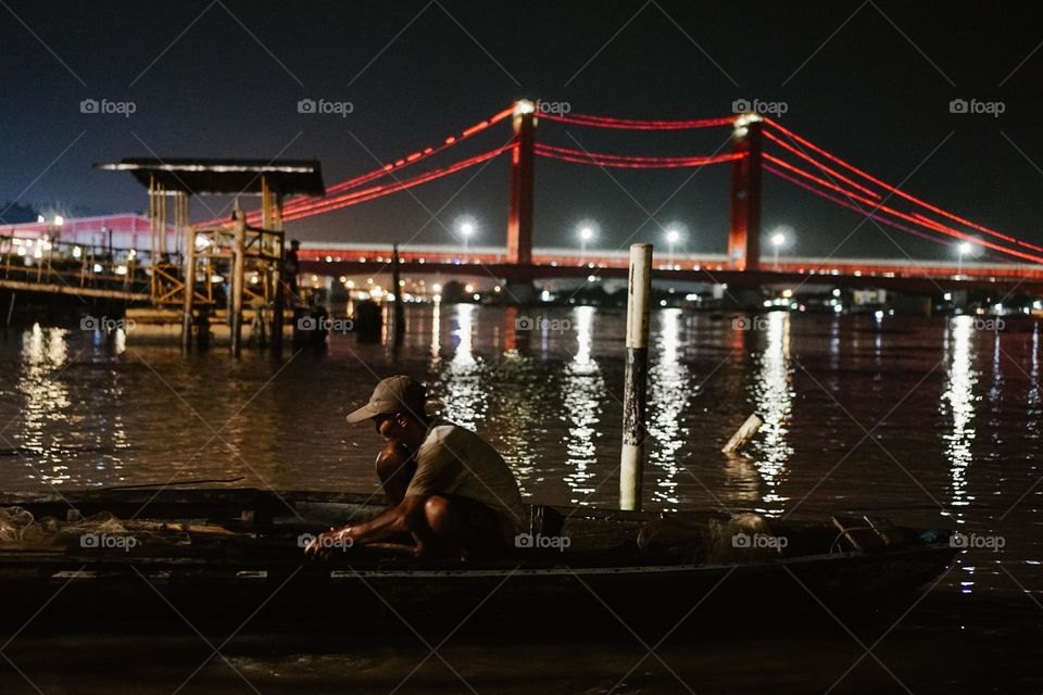Fisherman in the night at the river