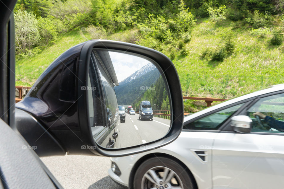 looking in the rear view mirrow on highway