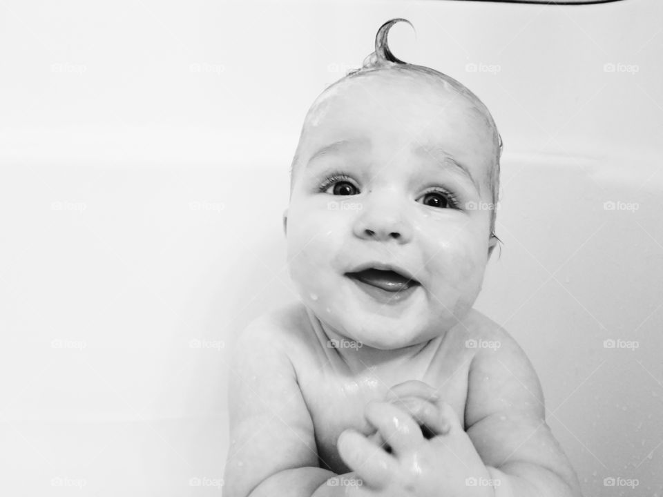 Cute baby playing in the bath - black and white