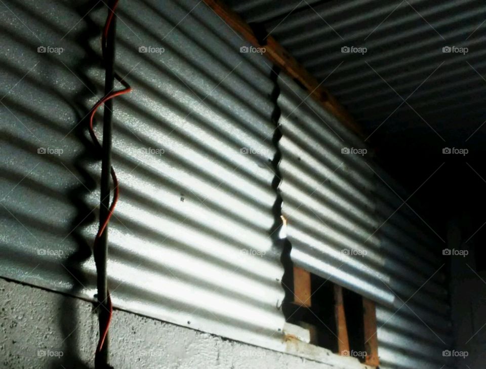 old tin siding inside building on wall