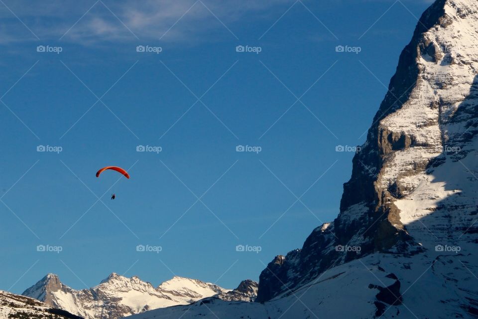 Paragliding over the Swiss Alps in the spring. 