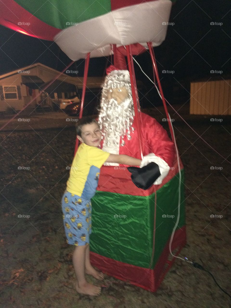 My son Caleb hugging our inflatable Santa the night before Christmas he’s absolutely an amazing sweet child .