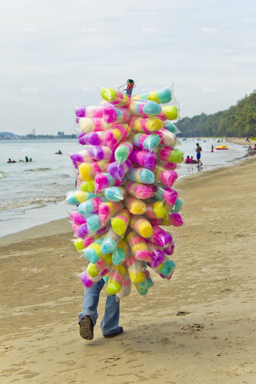 Colorful candy bags at the beach. street seller walking on the beach selling sweets