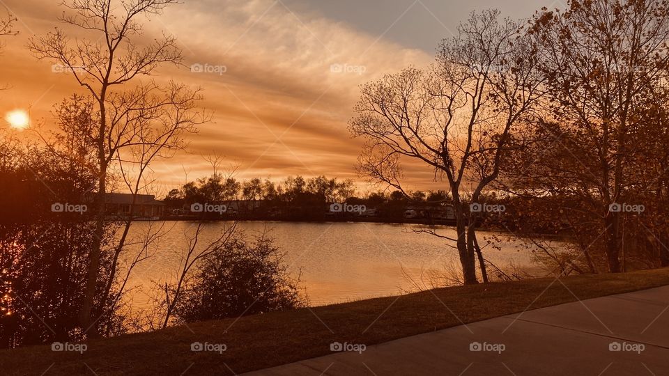 Strange looking cloud bank moved into the area with halos over sun colorful clouds enhancing sunset. 