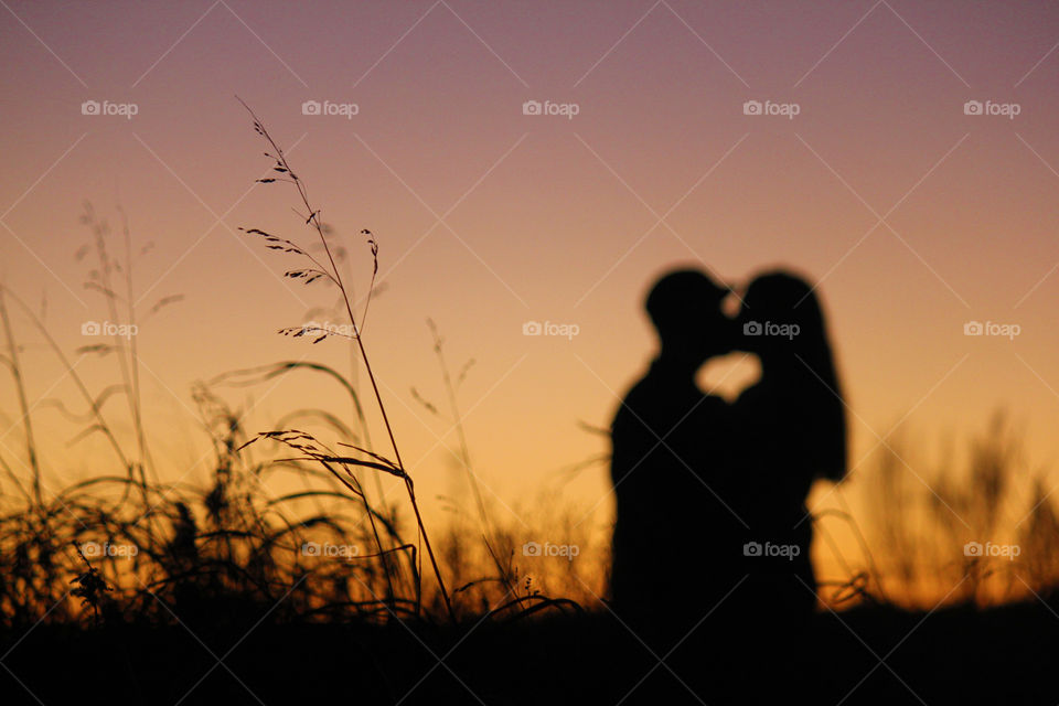 Silhouette of a couple kissing