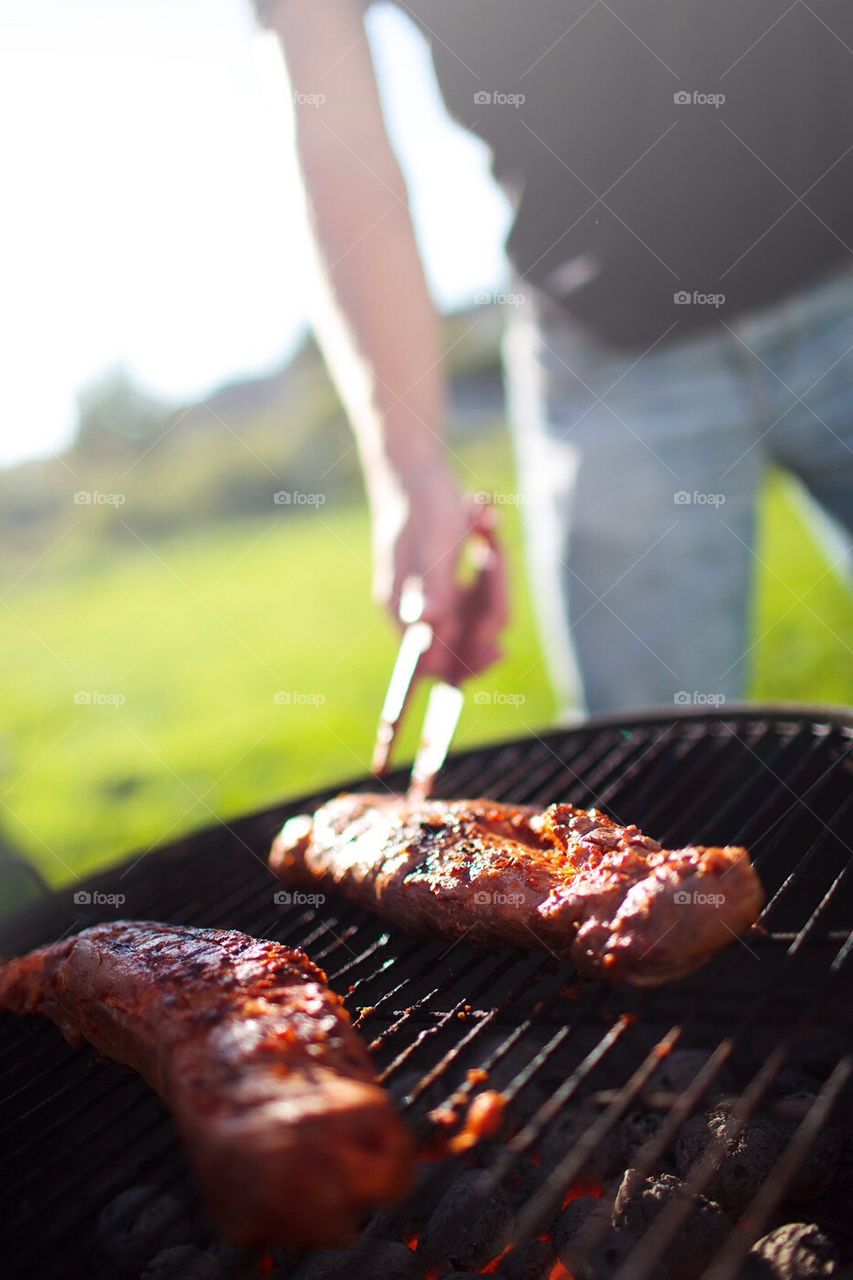 Man grilling pork