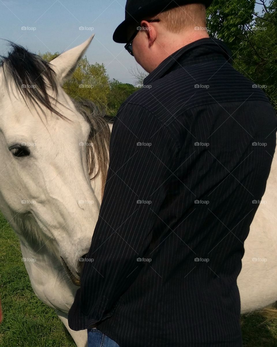 A man and a horse having a beautiful conversation