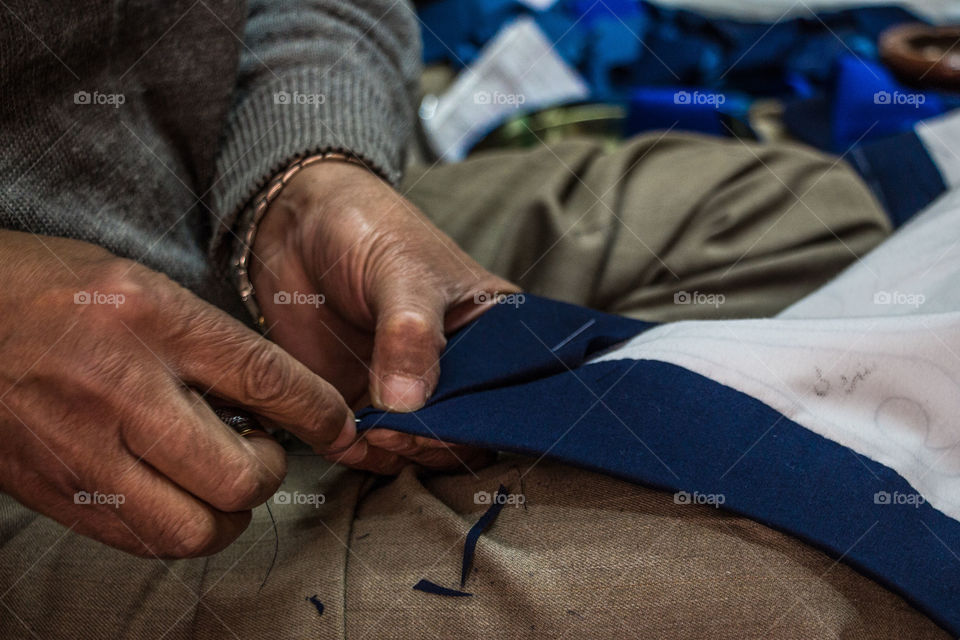 A man sewing cloth