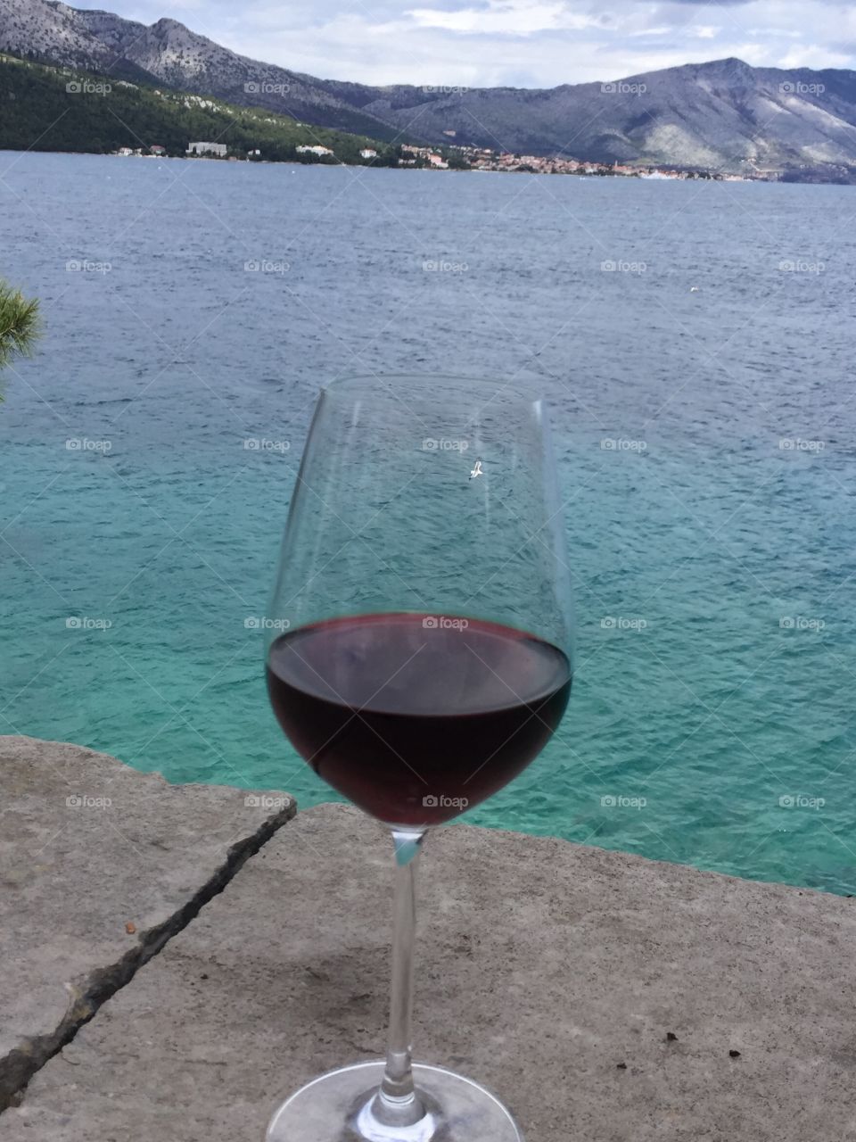 Glass of Croatian wine on the Adriatic Sea on the island of Krčula