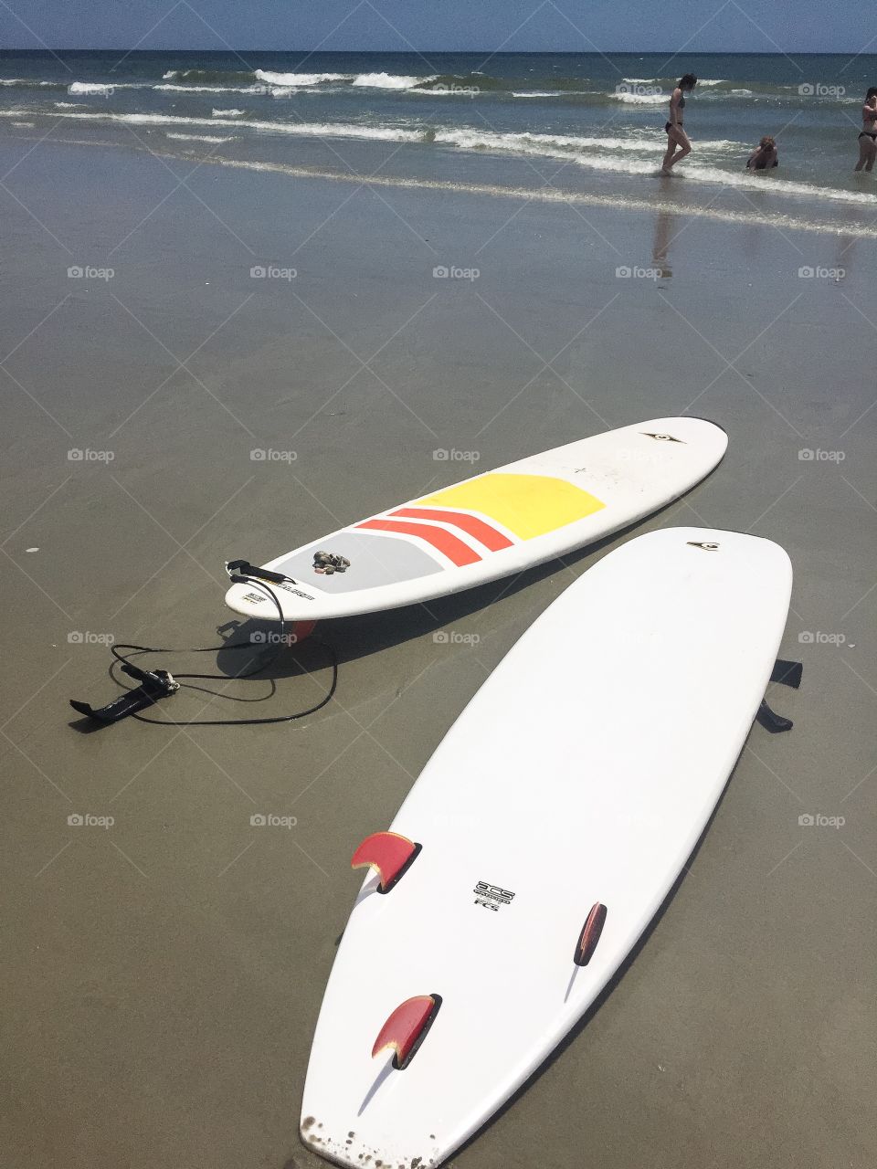 Surf boards laying in the sand in Myrtle Beach South Carolina.