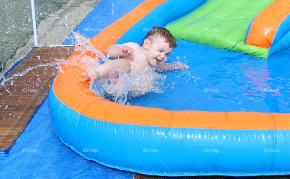 the child moves off the water slide