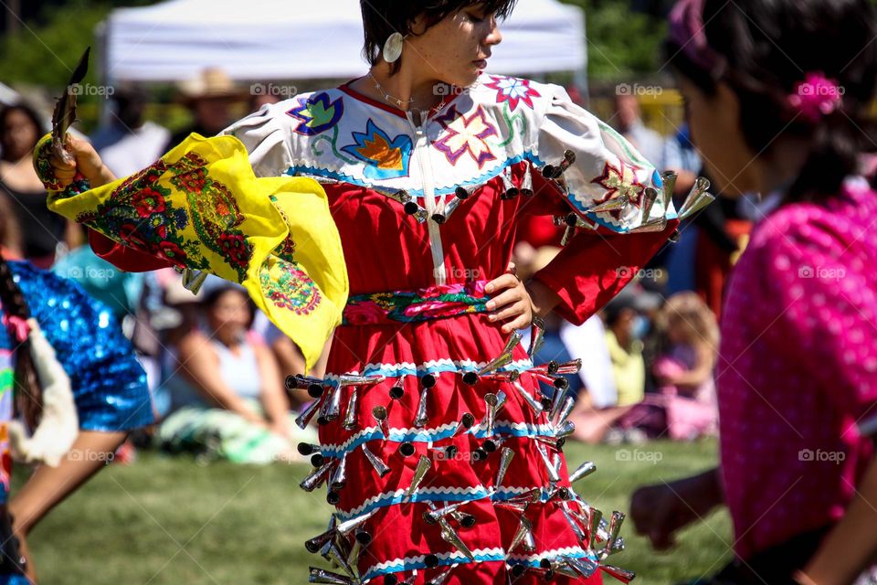 Beautiful first nations lady is dancing at the Pow-Wow