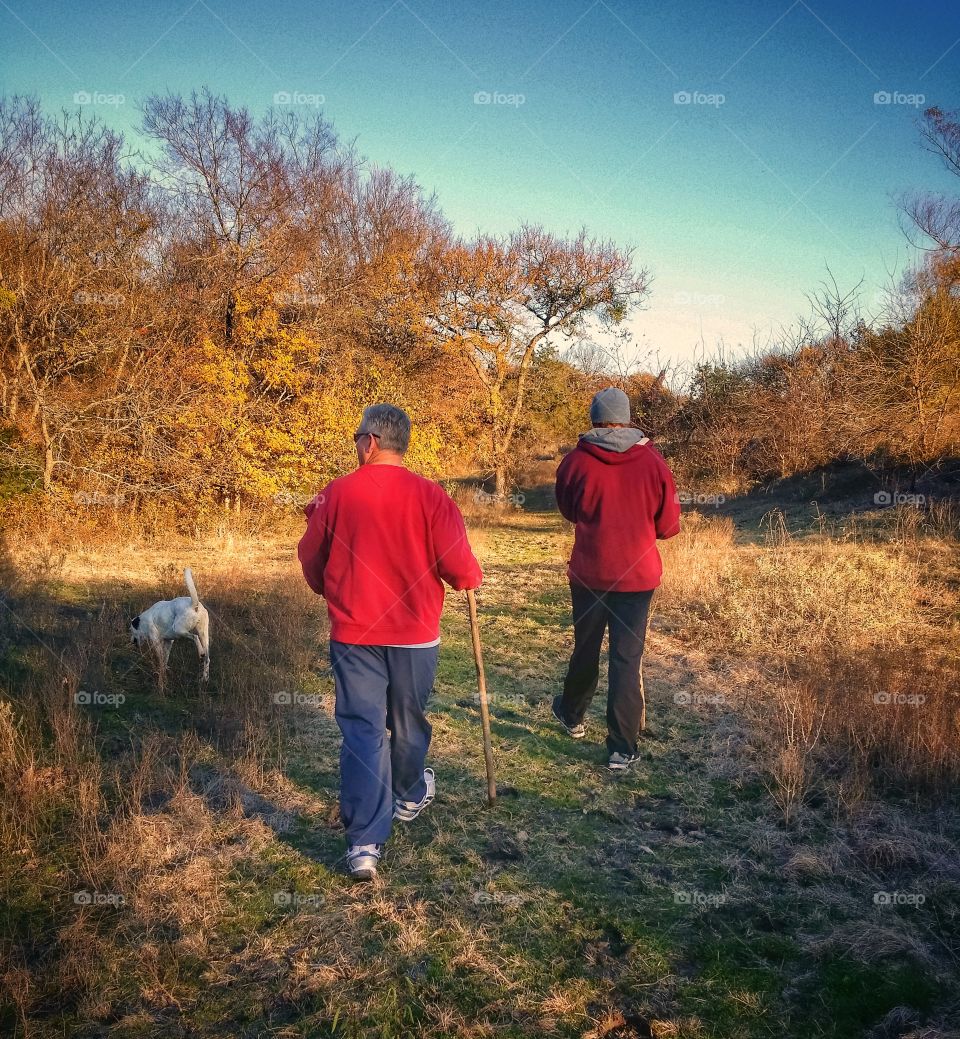 Father and Son Hiking with their Dog