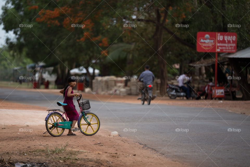 Girl ride bicycle in Countryside of the Siem Reap Cambodia